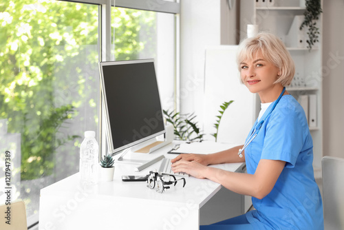 Female oculist working with...