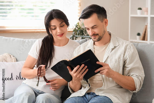 Religious couple with prayi...