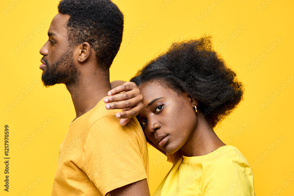 A young Black couple poses against a bright yellow background, showcasing their fashion style and emotional connection with a serene and thoughtful expression, perfect for modern lifestyle imagery A young Black couple poses against a bright yellow background, showcasing their fashion style and emotional connection with a serene and thoughtful expression, perfect for modern lifestyle imagery