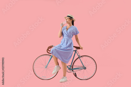 Young woman with bicycle dr...