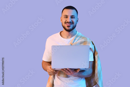 Young man using laptop on l...