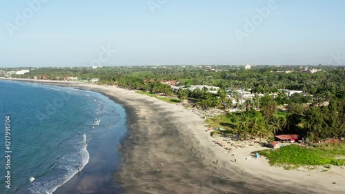 Aerial shot of a black sand beach on gambian coastline with hotels and local restaurants, Gambia, West Africa, 4K photo