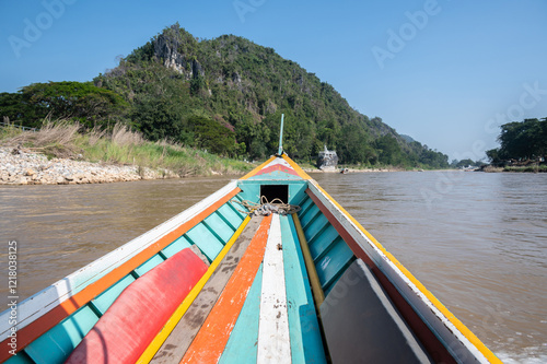 Long-tail boat perspective view while moving on Kok river the river that runs through the city of Chiang Rai province of Thailand. photo