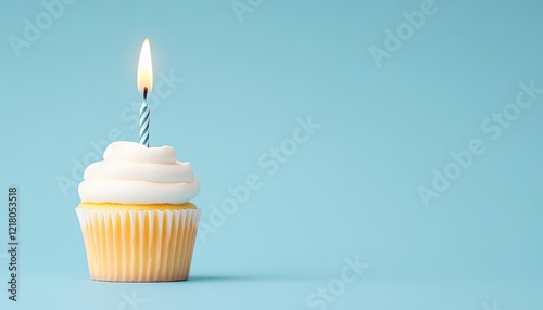 A single birthday cupcake with a lit candle against a soft blue background, symbolizing celebration