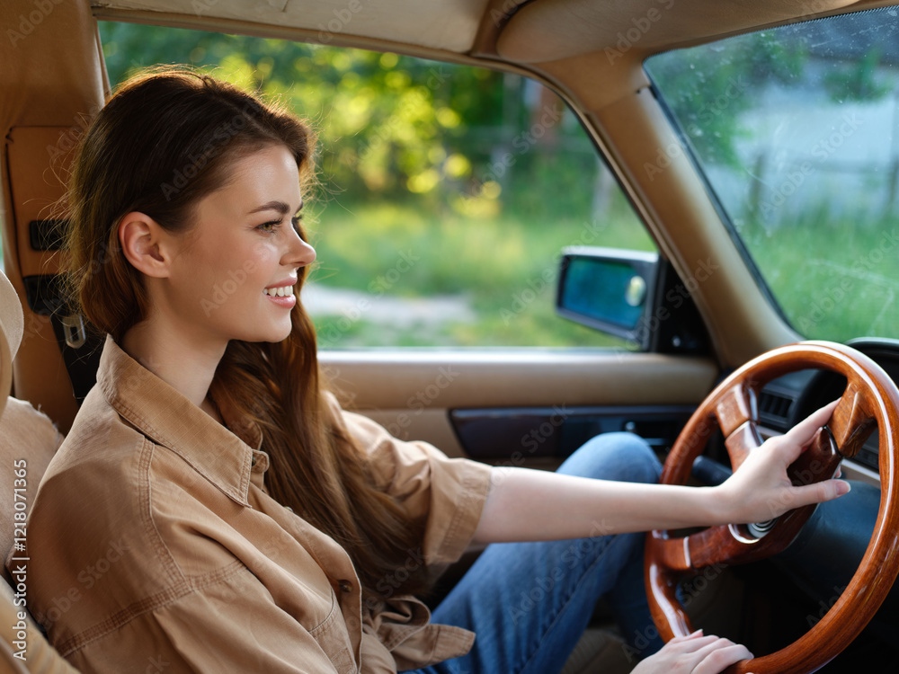 Fototapeta premium Smiling young woman driving a vintage car, wearing casual clothing, with a vibrant green background, evoking a sense of freedom and adventure.