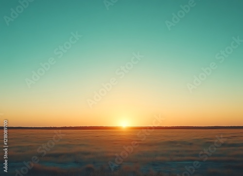 Sunset over flat grassy field.