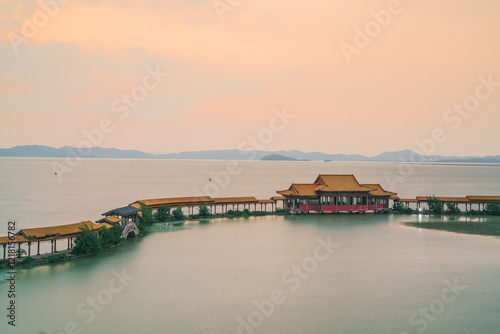 An ancient building complex and sunset scenery on the Taihu Lake Lake in Wuxi, Jiangsu Province, China will be on June 3, 2024 photo