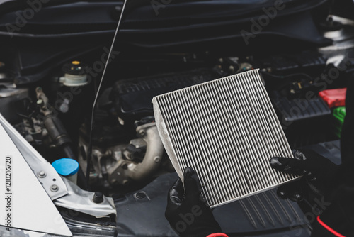 Car care maintenance servicing technician or auto mechanic holding car air conditioner filter for check and clean dirty or fix repair heat have engine problem or replace new change air filter.
