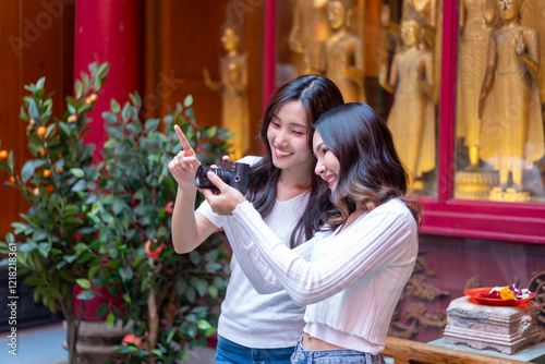 Friends Capturing Memories at Chinese Temple During New Year photo