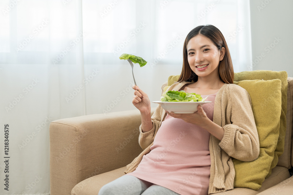 Happy pregnant woman eating vegetable salad and smiling to camera, concept of healthy mother taking health care and nourish her fetal and waiting her childbirth. Happy pregnant woman eating vegetable salad and smiling to camera, concept of healthy mother taking health care and nourish her fetal and waiting her childbirth.