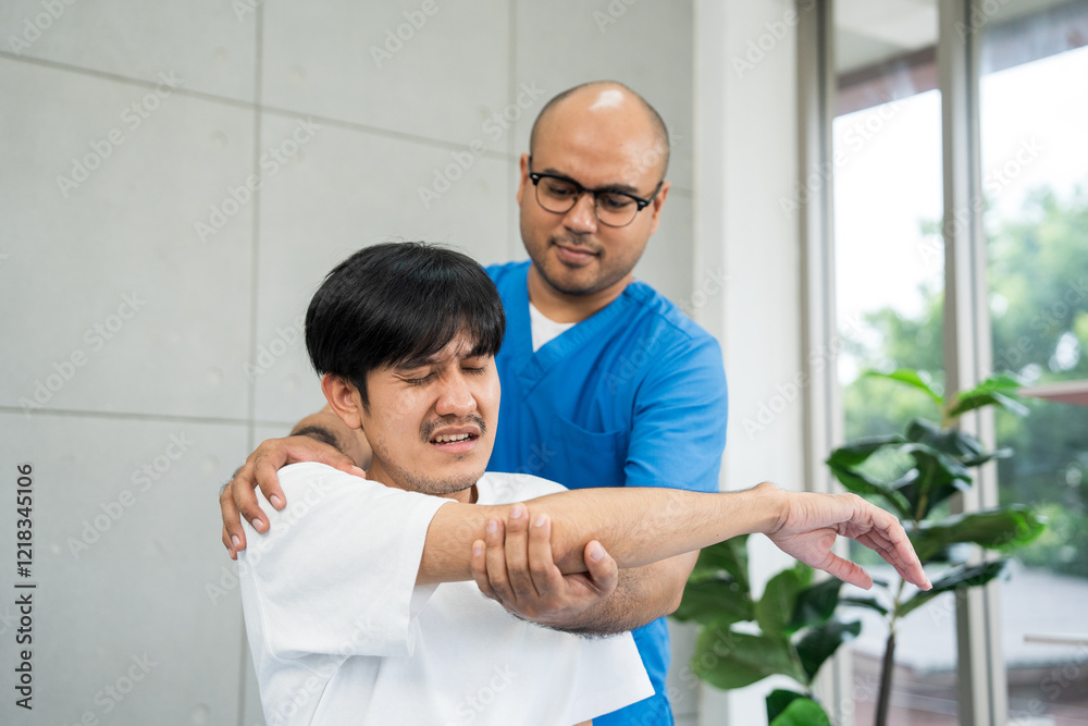 Fototapeta premium Physical therapy. Male Nurse aids young man in recovering from spine injury and providing orthopedic massage Orthopedic healthcare and chiropractor with person for physical therapy rehabilitation