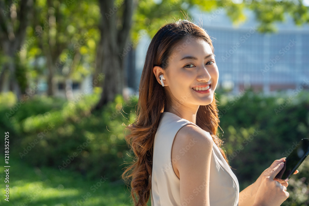 Young asian business woman with headset talking on smartphone standing in the garden public park. Cheerful woman discussion conference on smartphone Young asian business woman with headset talking on smartphone standing in the garden public park. Cheerful woman discussion conference on smartphone