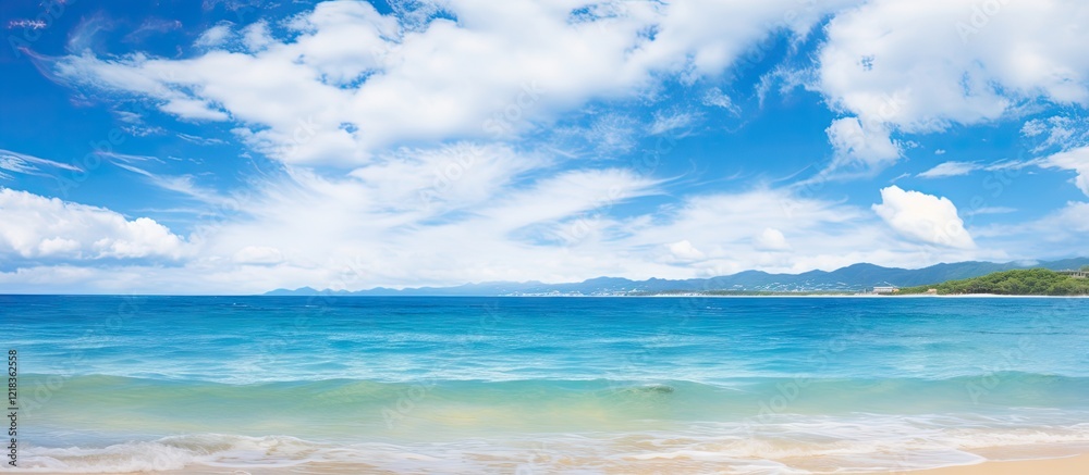 Fototapeta premium Tranquil seascape of Miyakojima Okinawa featuring a clear blue ocean blending into a vibrant sky with fluffy white clouds and ample sandy shore space