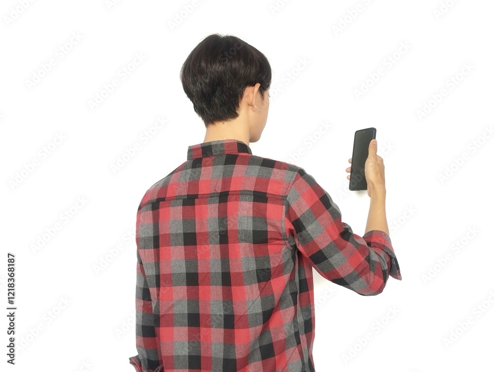 Rear view of a man looking at the cell phone he is holding, looking at the cell phone Rear view of a man looking at the cell phone he is holding, looking at the cell phone