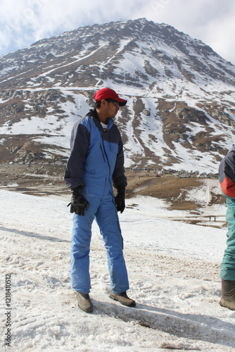 Men wearing cap at snow mountains for snow skating at manali	 photo