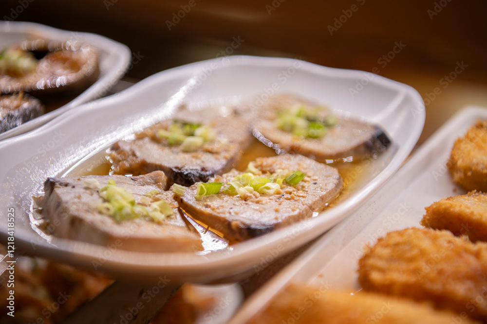 Marinated ahi tuna on display on white plate in okazuya Japanese deli Marinated ahi tuna on display on white plate in okazuya Japanese deli