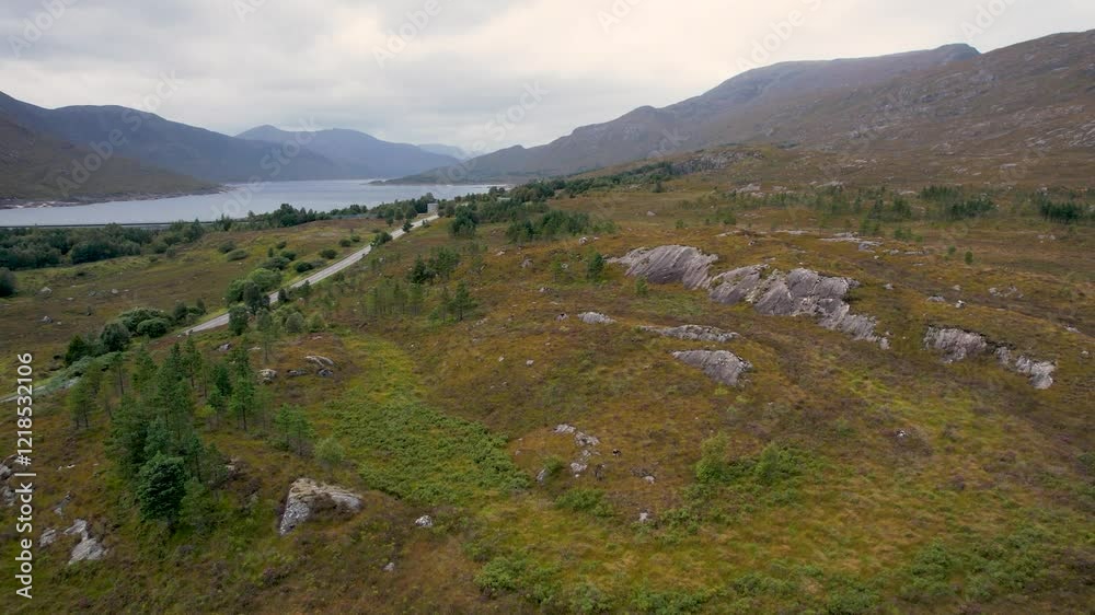 Scottish highlands aerial view of road, lakes and mountain with no people Scottish highlands aerial view of road, lakes and mountain with no people