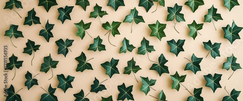 Ivy leaves arranged symmetrically on a plain beige background