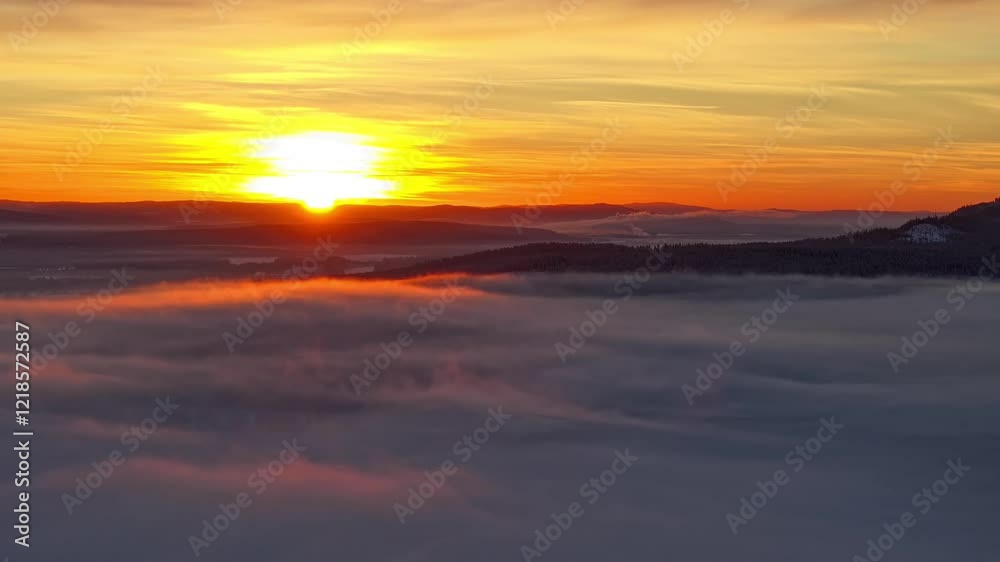 Drone timelapse over a majestic layer of low clouds, waving under sunset sky with bright sun Drone timelapse over a majestic layer of low clouds, waving under sunset sky with bright sun