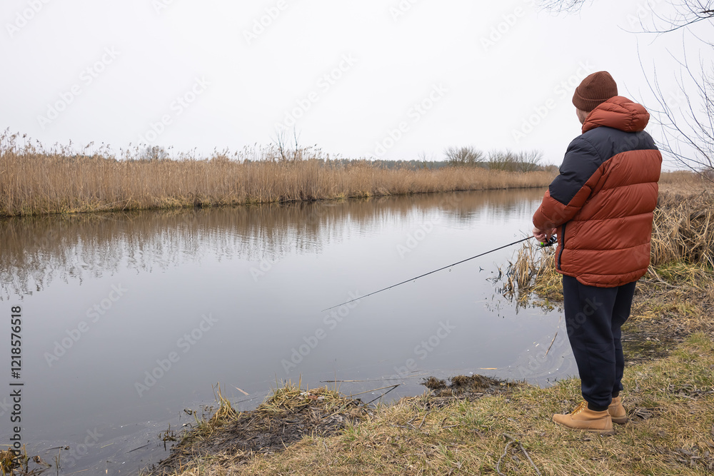 Fishing on the river. Fly fisherman catches fish in the morning Fishing on the river. Fly fisherman catches fish in the morning