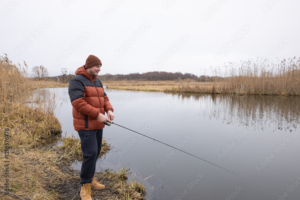 Fly fisherman catching fish in the river Fly fisherman catching fish in the river