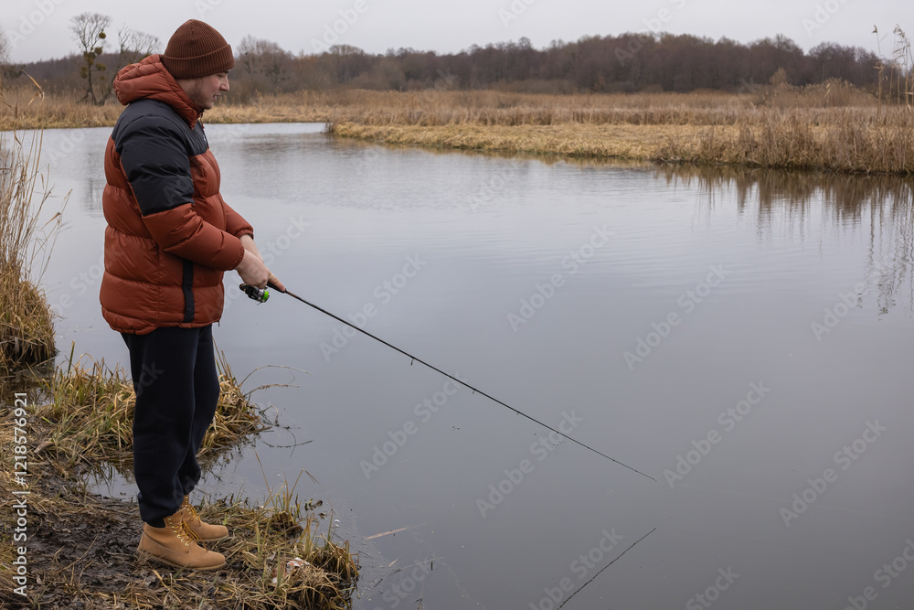 Fly fisherman catching fish in the river Fly fisherman catching fish in the river