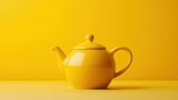 Bright yellow teapot displayed on a simple yellow background for a cheerful kitchen decor idea