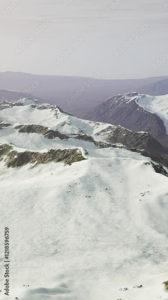 large snow patch left over on the volcanic rock field of a mountain in summer
