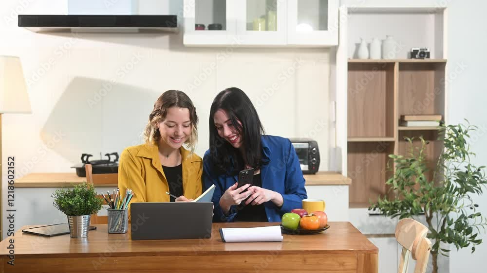 Modern collaborating over coffee in a cozy kitchen setting with a laptop, notebook, and breakfast. Modern collaborating over coffee in a cozy kitchen setting with a laptop, notebook, and breakfast.
