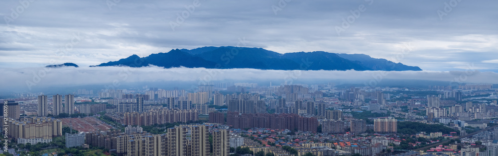 blue mountains on urban clouds and mist panorama