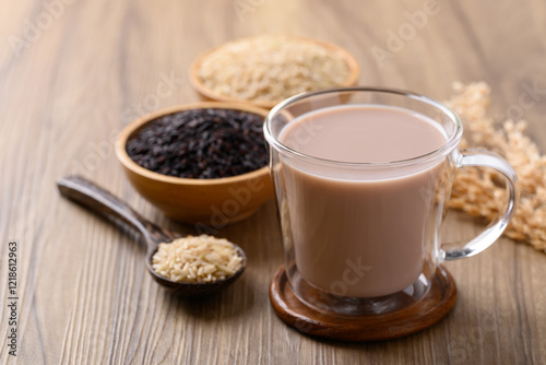 Organic rice milk in cup glass on wooden background, Alternative milk made from plant, non dairy photo