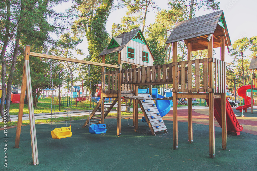 wooden new empty playground with slides, swings, climbing structures, in a sunny park surrounded by trees, featuring colorful elements and a safe play area, concept of childhood and outdoor activities wooden new empty playground with slides, swings, climbing structures, in a sunny park surrounded by trees, featuring colorful elements and a safe play area, concept of childhood and outdoor activities