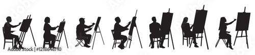 artist sitting on chair and painting on canvas