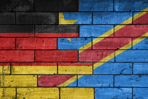 colourful painted big flag of germany and flag of democratic republic of the congo on a massive old brick wall background. concept