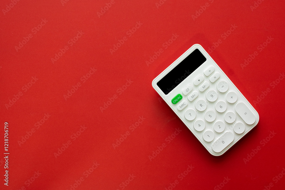 Minimalist white calculator isolated on red backdrop, perfect for business, education,financial,mathematics,accounting. Minimalist white calculator isolated on red backdrop, perfect for business, education,financial,mathematics,accounting.