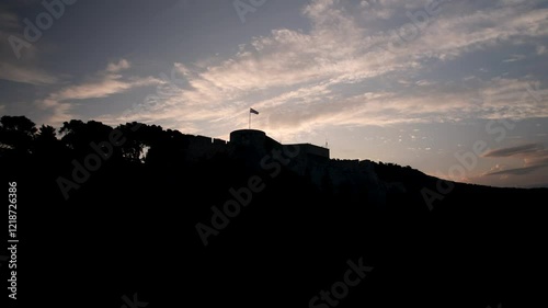 Dolly in drone shot close to Tvrdalj Castle silhouette at sunrise in Hvar, Croatia photo