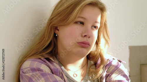 A close-up of a sad young student leaning against a wall, her face reflecting stress and loneliness. This image highlights themes of teenage depression, academic pressure, and emotional struggles.
