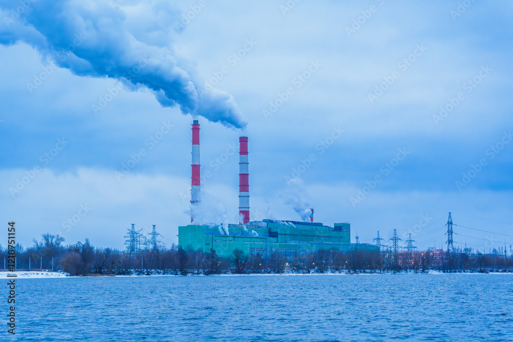 Industrial power plant with smoking chimneys on a winter day Industrial power plant with smoking chimneys on a winter day