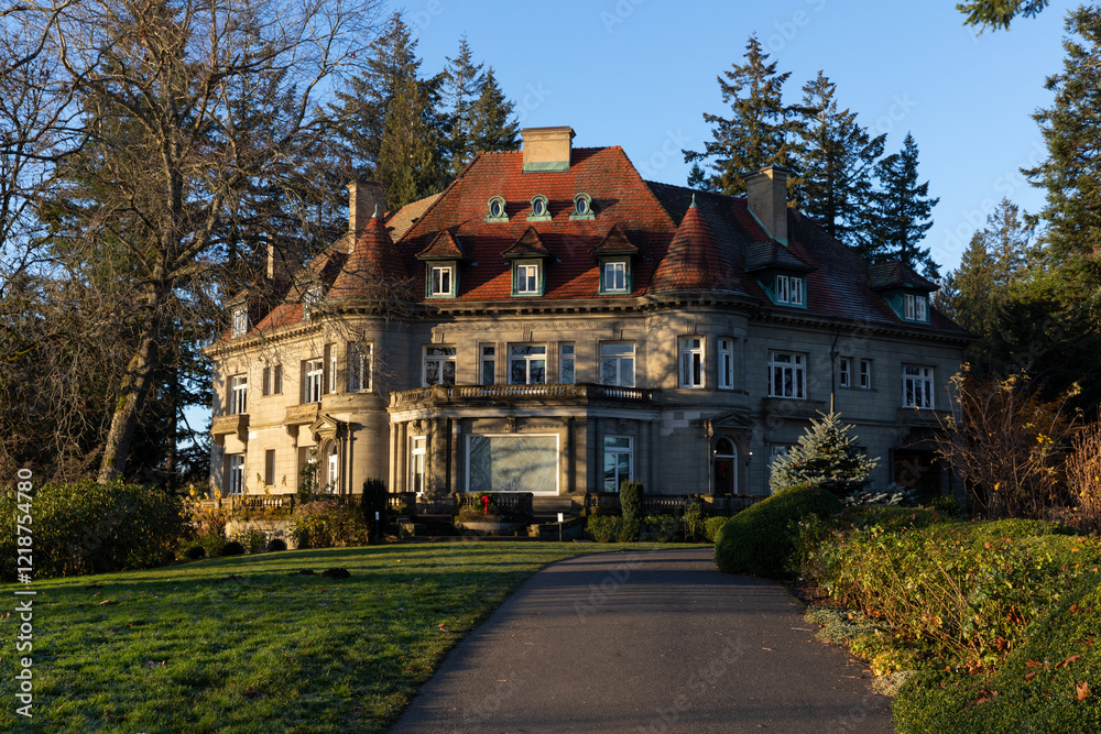 Elegant view of the historic Pittock Mansion in early morning (sunrise) sunlight, surrounded by lush greenery and trees, a landmark offering breathtaking views of Portland Elegant view of the historic Pittock Mansion in early morning (sunrise) sunlight, surrounded by lush greenery and trees, a landmark offering breathtaking views of Portland