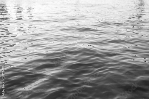 Water surface with ripples and sunlight reflections