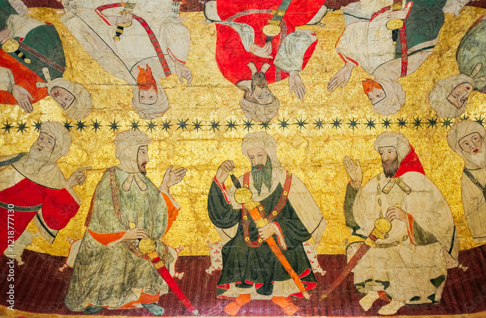 Naklejka premium detail of painting and gold leaf with an Arabic and Moorish style scene on a vaulted ceiling of the Nasrid palaces of the Alhambra, Granada, Spain