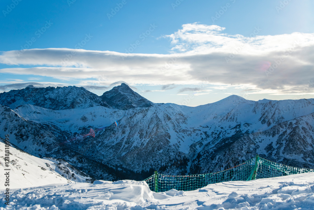 Obraz premium Tatra mountains at winter time. View of the white snow-capped peaks, frosty winter mountains. Kasprowy Wierch, High Tatra, Poland, Europe.