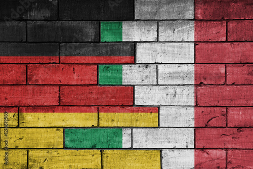 Fototapeta Naklejka Na Ścianę i Meble -  colourful painted big flag of germany and flag of italy on a massive old brick wall background. concept