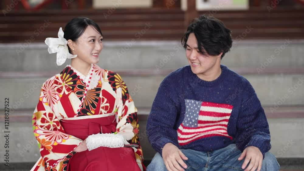A young woman in her twenties is a traditional graduation ceremony in Japan, sitting in a large wooden auditorium wearing a hakama (kimono) in a sweater. A young woman in her twenties is a traditional graduation ceremony in Japan, sitting in a large wooden auditorium wearing a hakama (kimono) in a sweater.