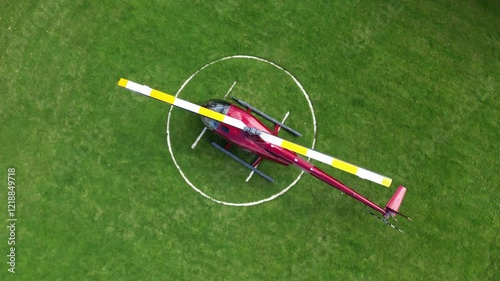 helicopter parked green grass field heliport vibrant colors perspective highlight aviation london dynamic rotating aerial drone shot helipad scenic view travel air 
