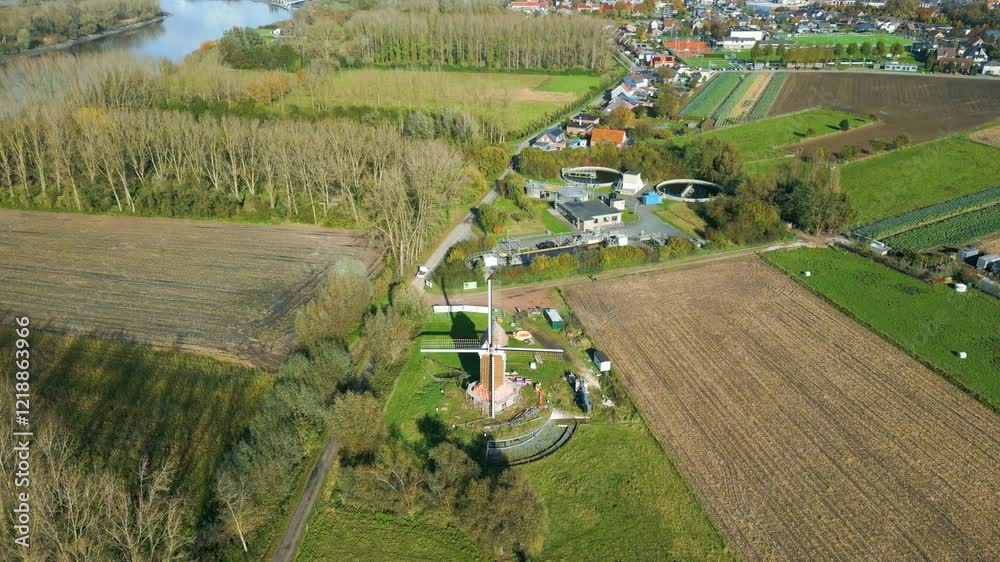 vintage windmill's blades while revealing picturesque countryside gansakkermolen belgium sunny weather enhances visual appeal historical downward aerial shot newly built 