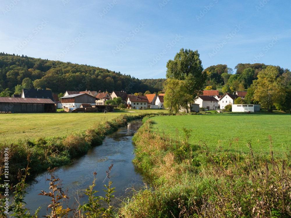 Fototapeta premium Schwaebische Alb, Germany - October 2nd 2023: Idyllic valley of the Lauter river with villages and fields