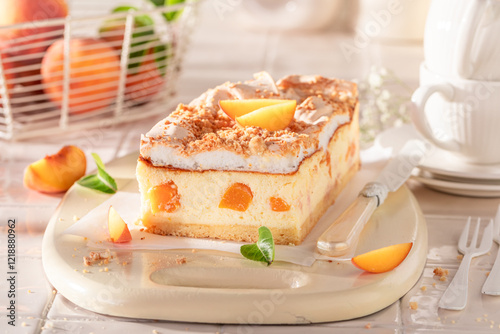 Tasty and delicious cheesecake with peaches served on kitchen.