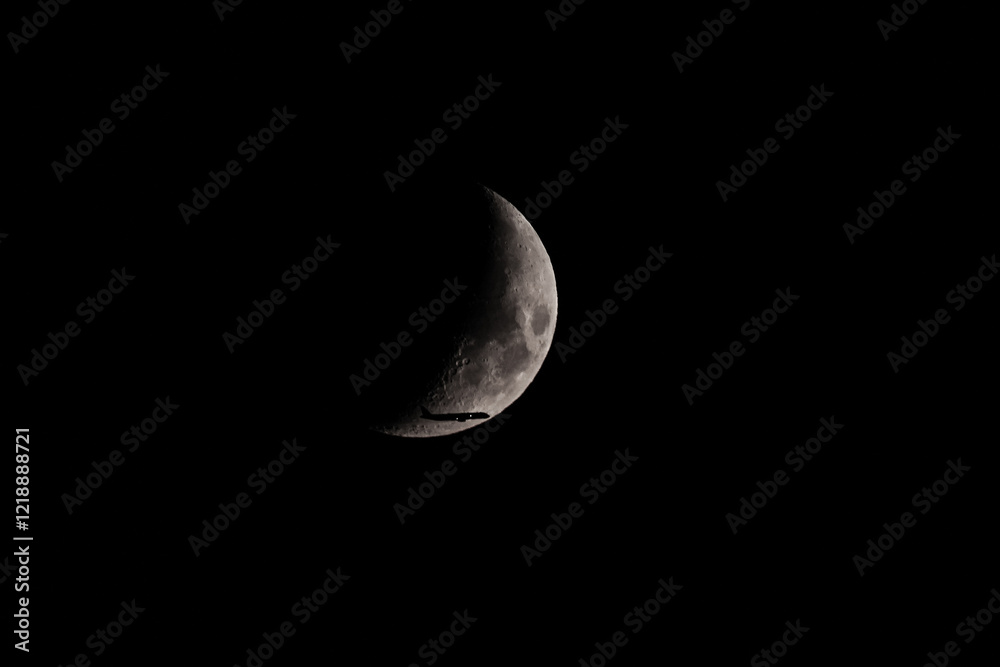 Silhouette of an Airplane in front of Moon Silhouette of an Airplane in front of Moon