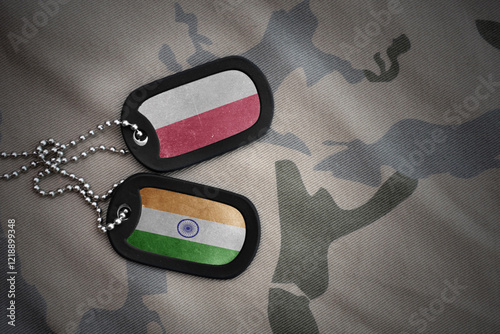 vintage army blank, dog tag with flag of poland and india on the khaki texture background. military concept. photo